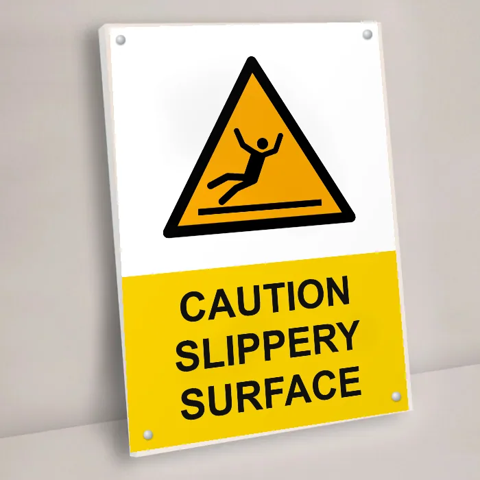 Safety signs: caution slippery surface sign on a wall